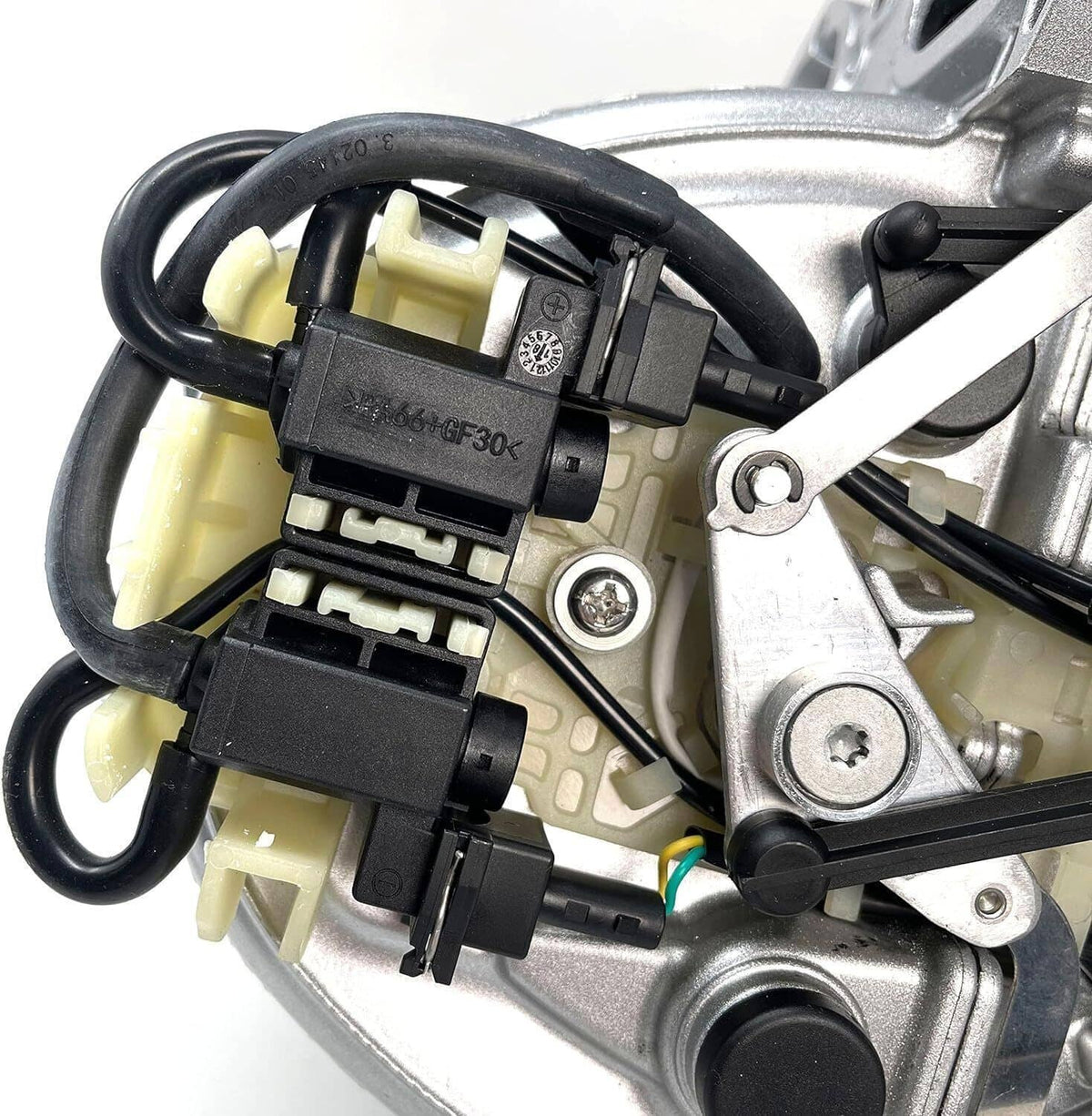 Close-up of intake manifold electrical connectors on silver housing