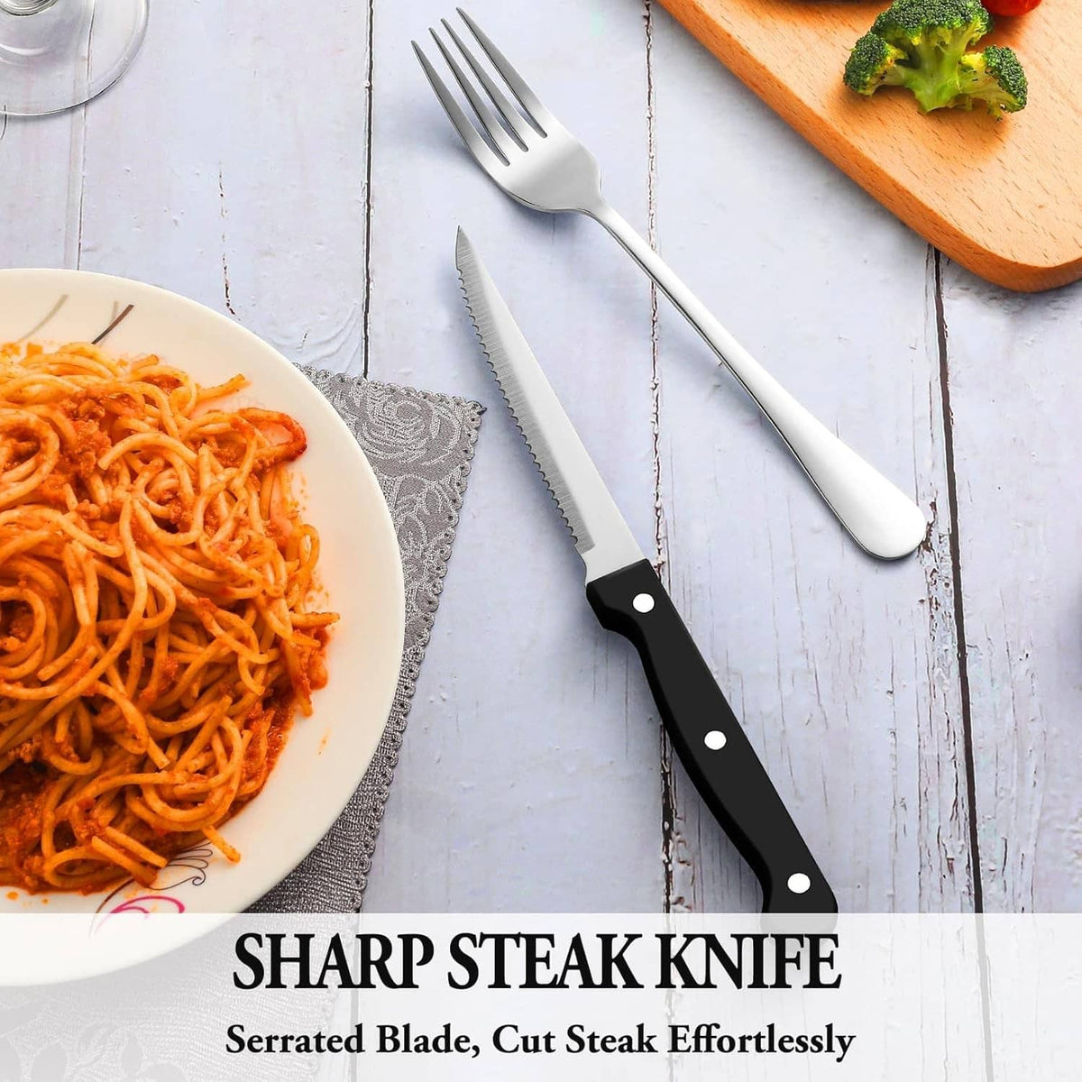 Black-handled serrated steak knife with matching forks and spoons
