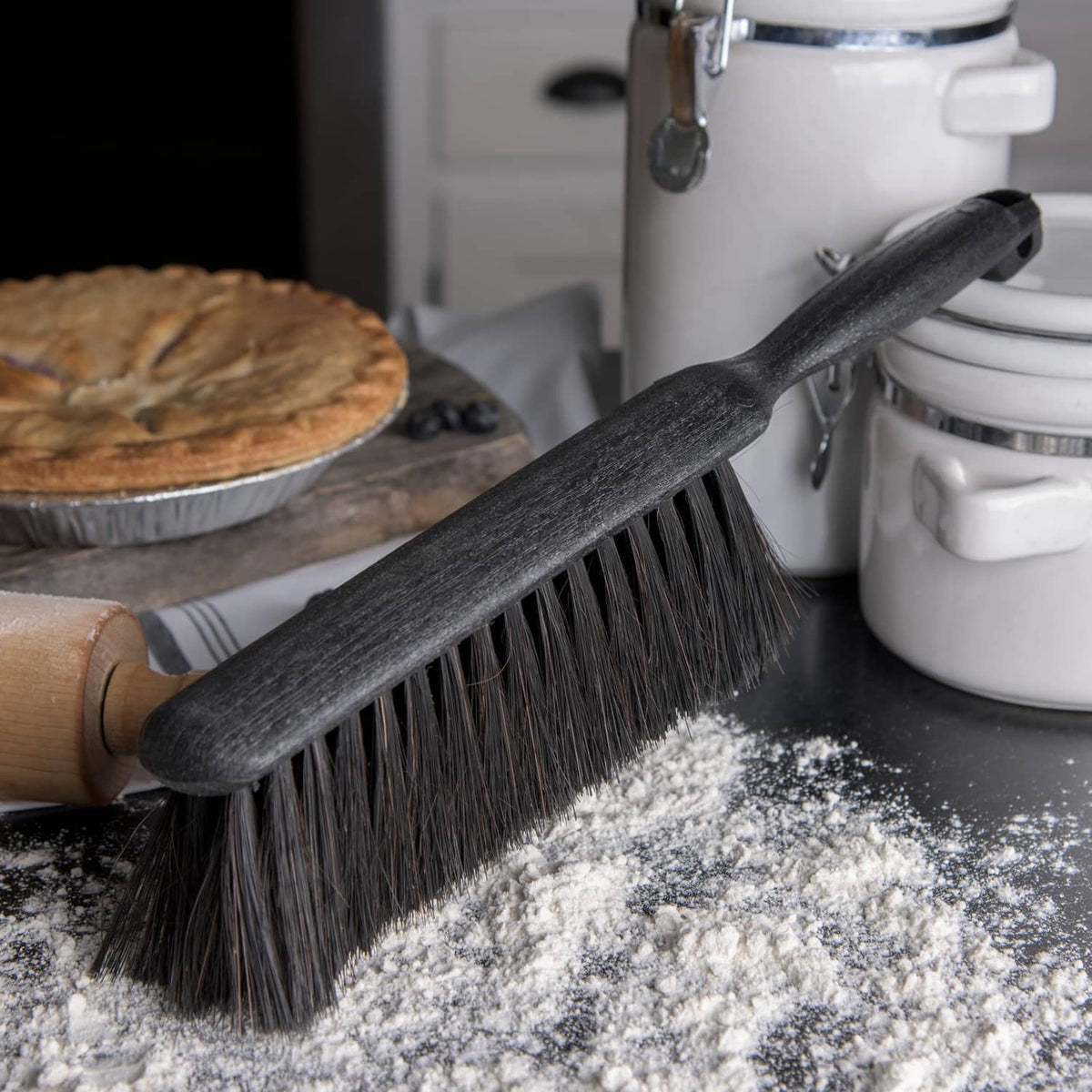 Black counter brush with angled bristle head for sweeping crumbs from counters