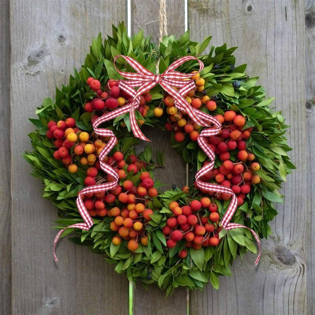 Red and white gingham ribbon bow on green wreath, thin striped ribbon for decoration