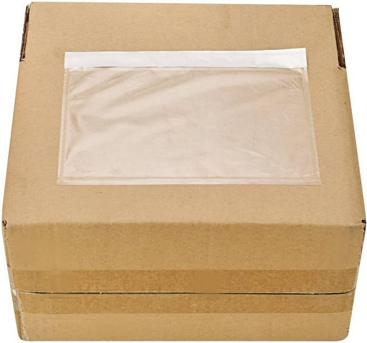 Clear adhesive top-loading packing list pouch, empty, on brown shipping box