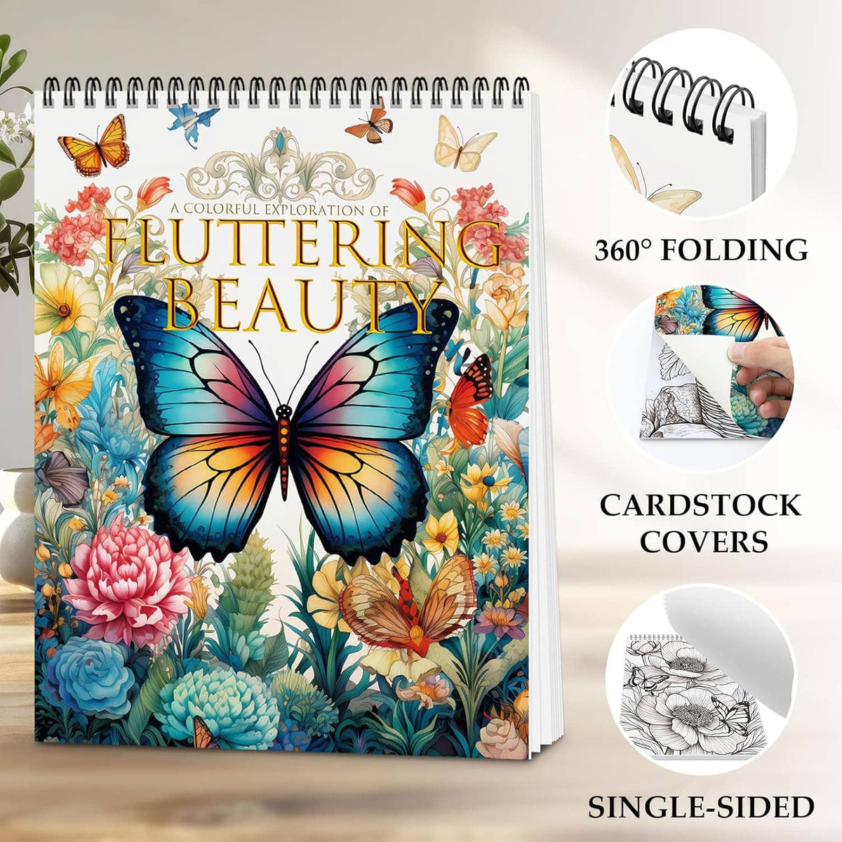 Spiral-bound adult coloring book with colorful butterfly and floral cover, shown with folding feature icons