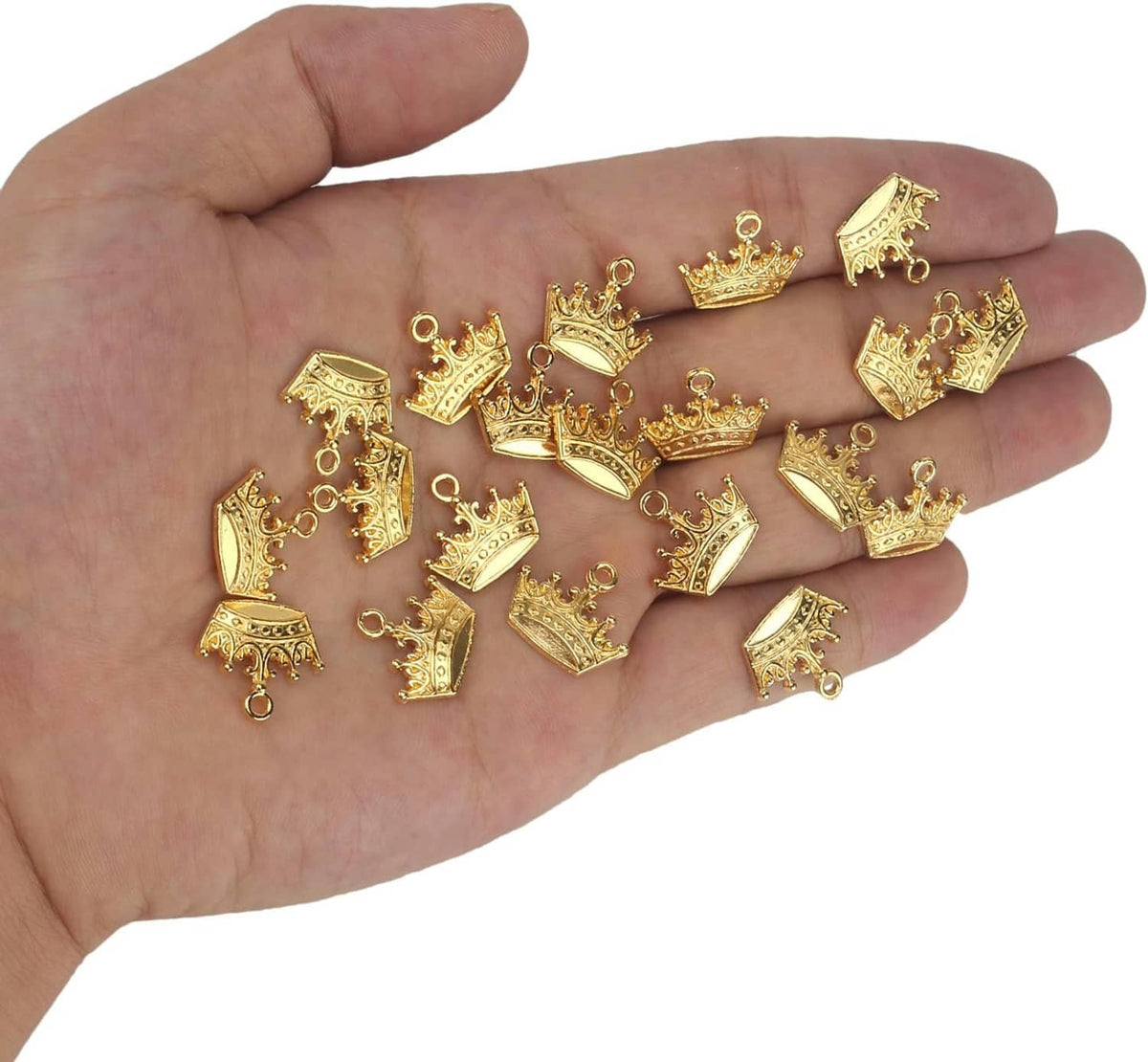 Gold crown charm pendants shown in hand, ornate vintage tiara style