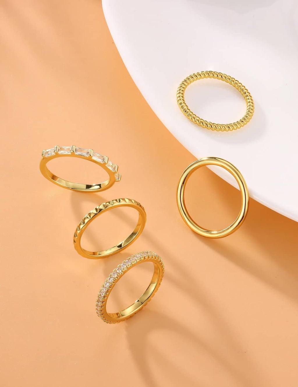 Gold-plated ring set with five thin bands, one with small clear stones
