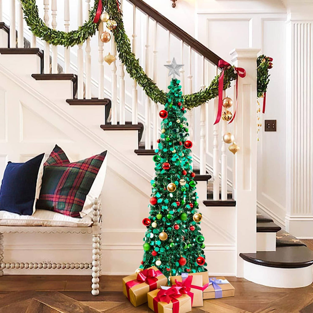 Prelit Christmas tree with star topper, green branches with gold red ornaments and lights