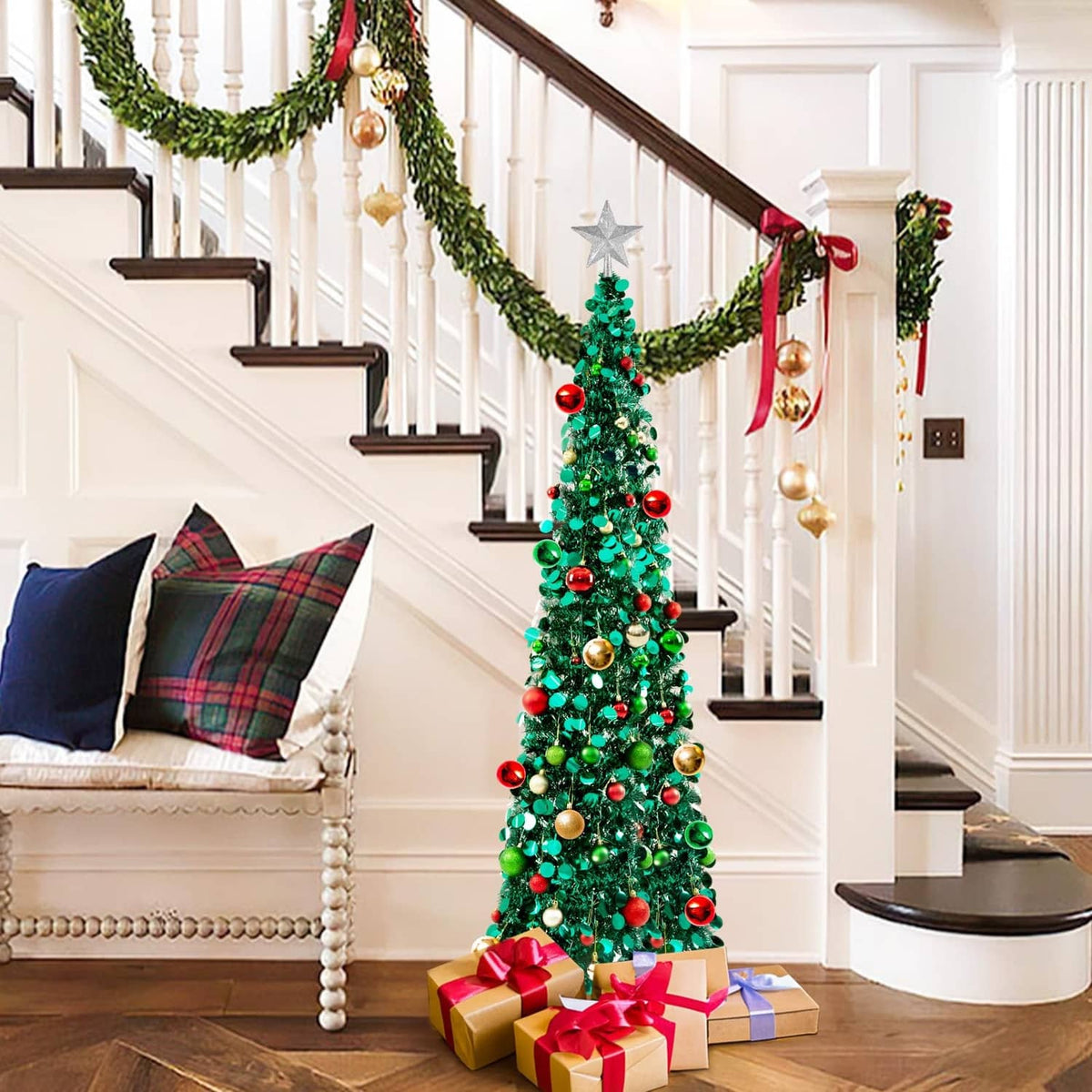 Prelit Christmas tree with star topper, green branches with gold red ornaments and lights