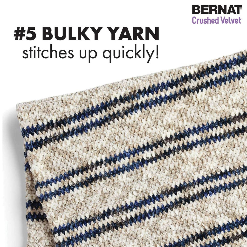 Close-up of chunky knit fabric with cream and navy horizontal stripes.
