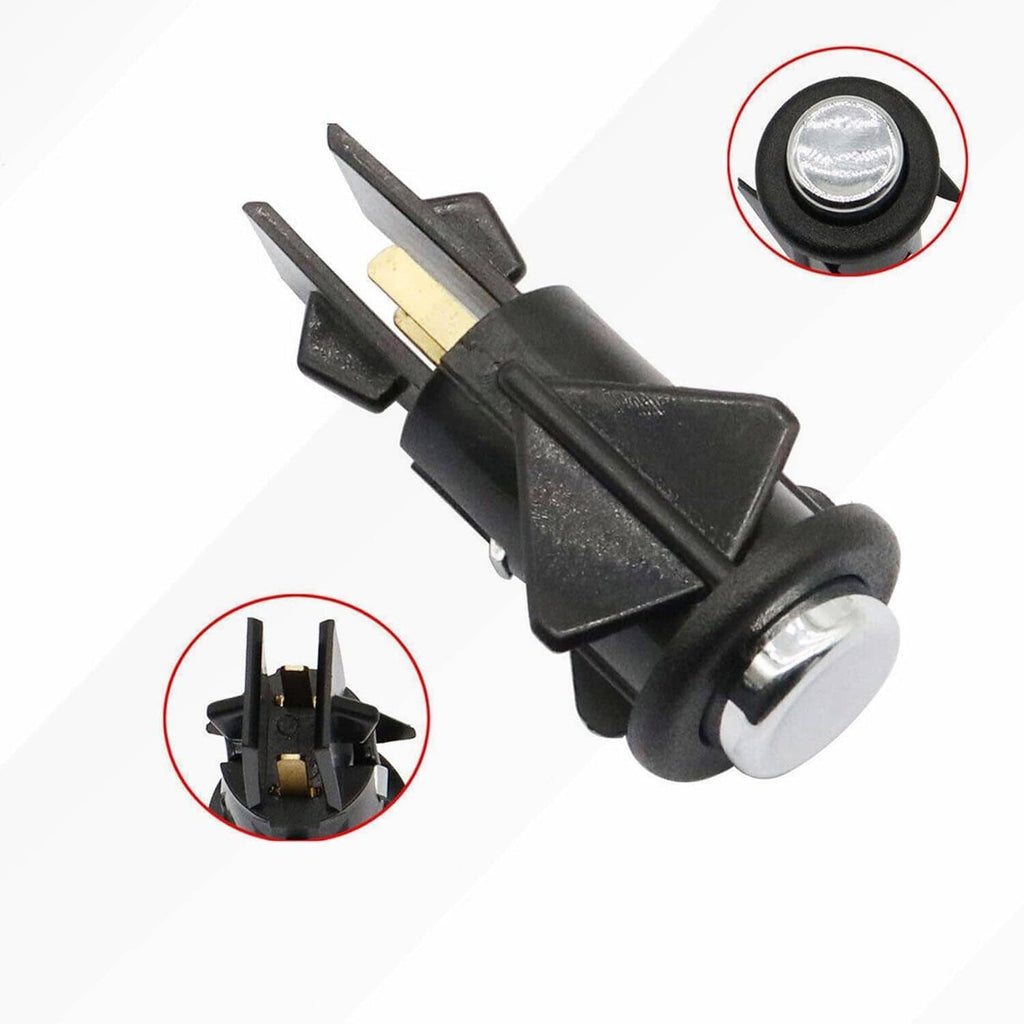 Black fuel door release switch with chrome button and connector detail inset