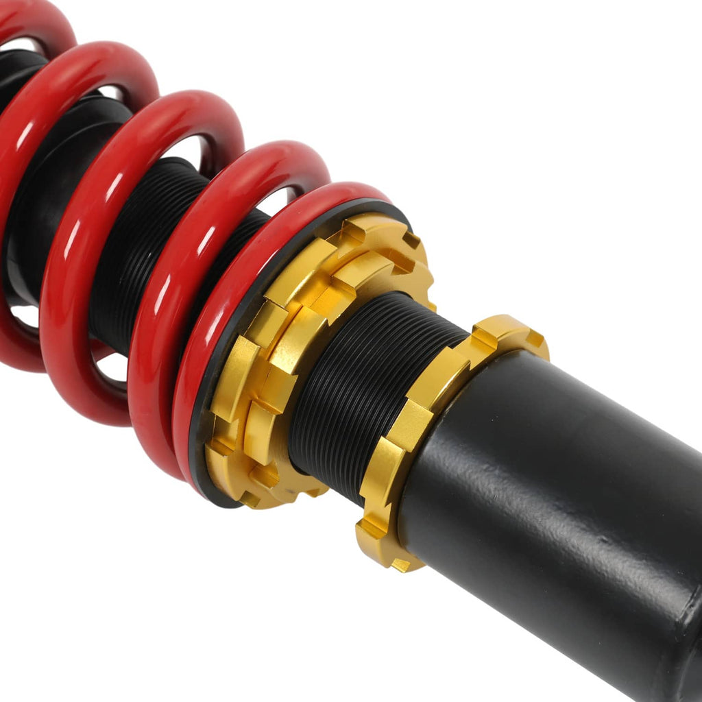 Close-up of red spring, gold collar, and black threaded shock body