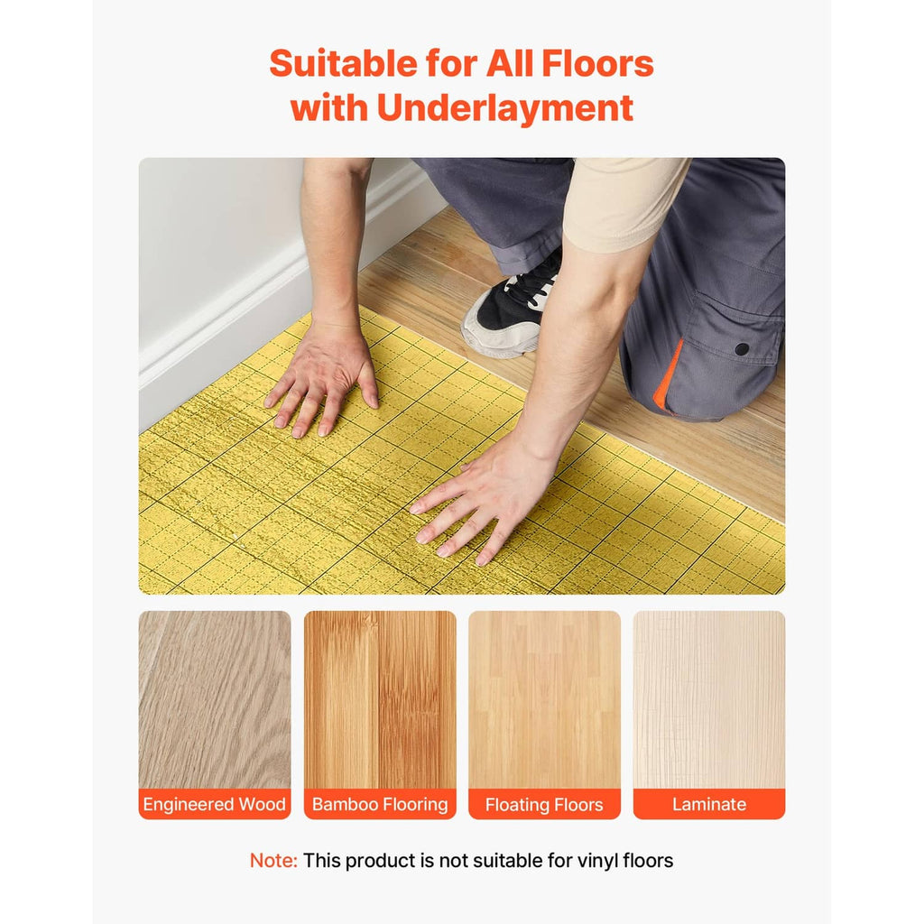 Hands installing gold floor underlayment with grid lines on a wood subfloor