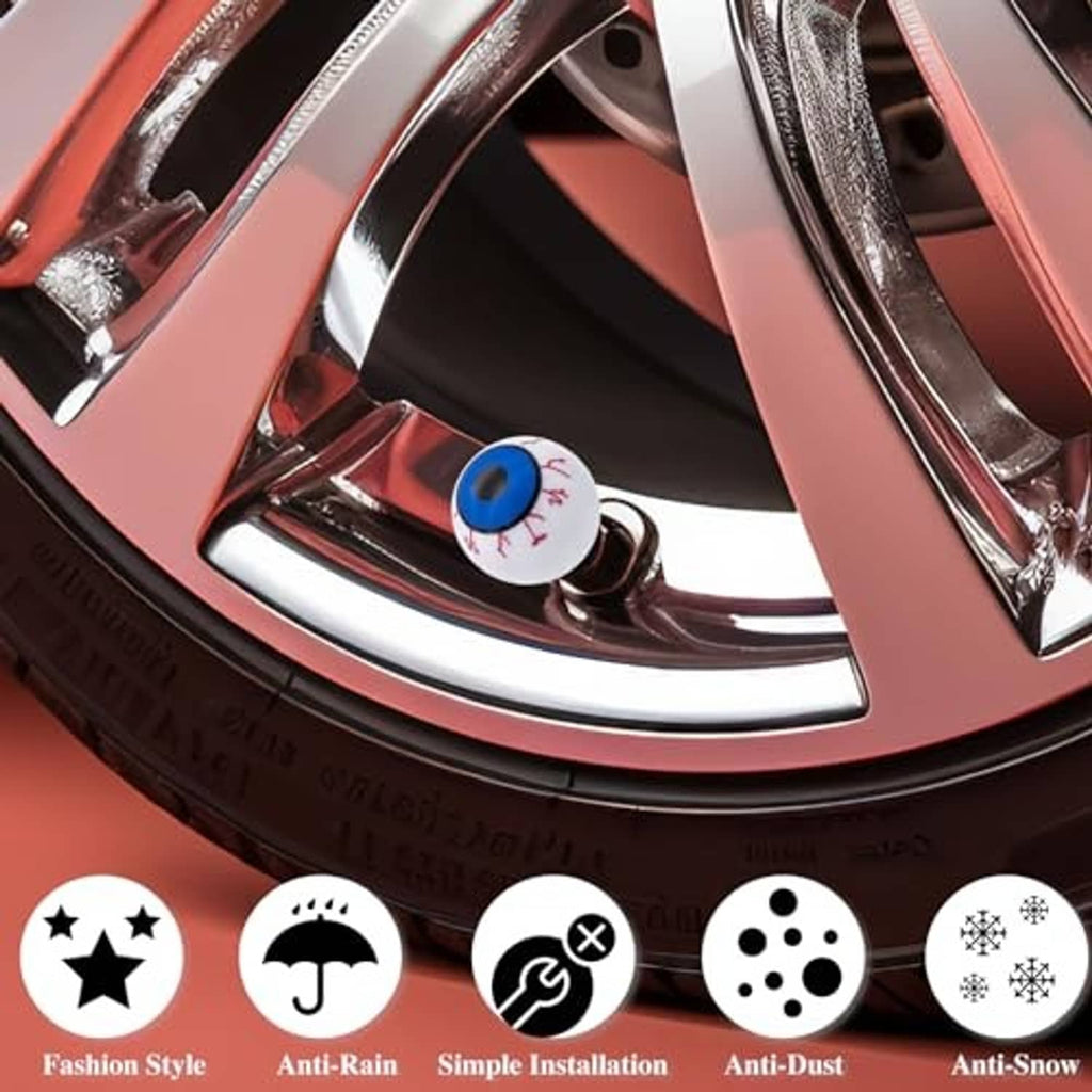 Close-up of an eyeball tire valve stem cap on a wheel rim, white with blue eye top