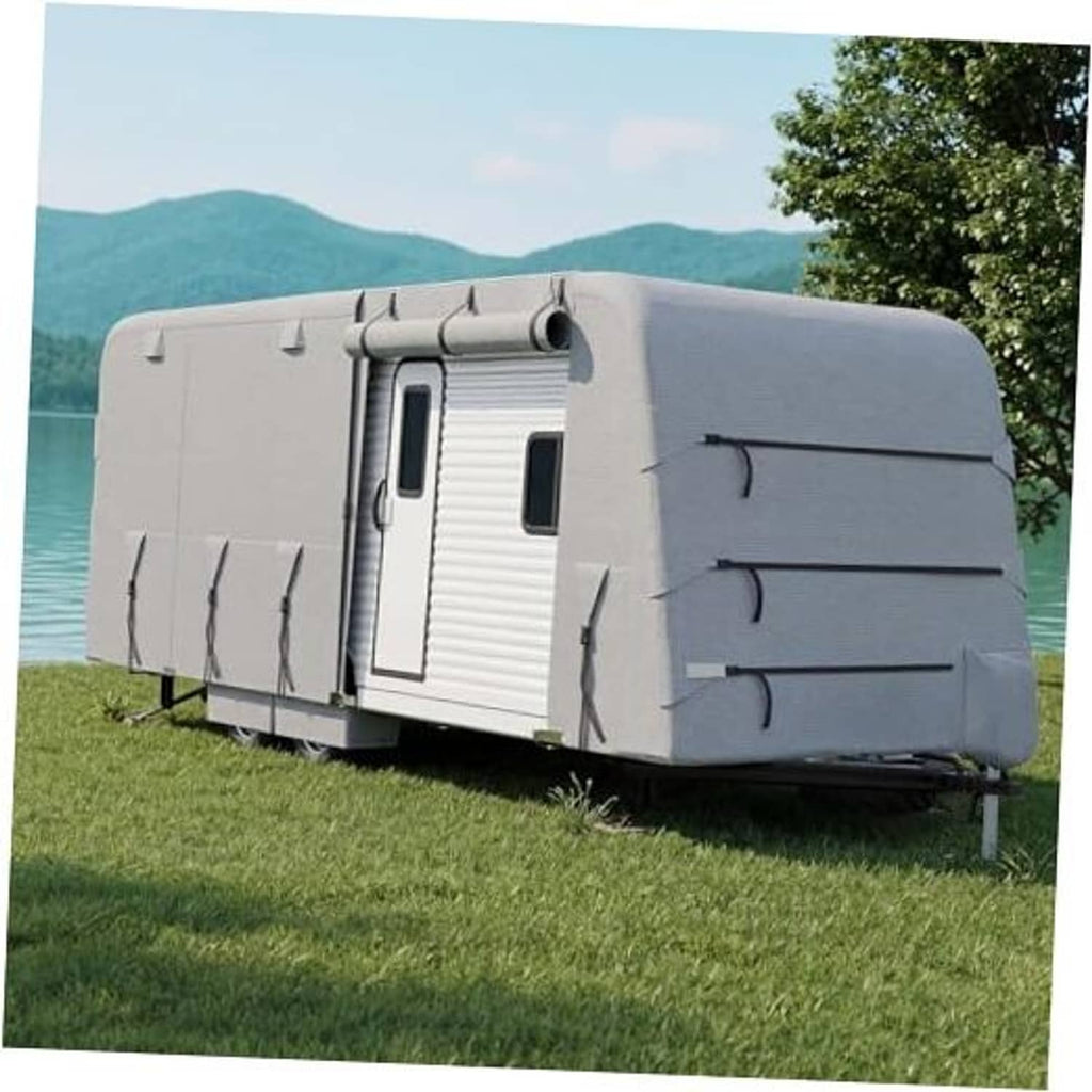 Grey RV travel trailer cover draped over trailer with zippered side panels and straps