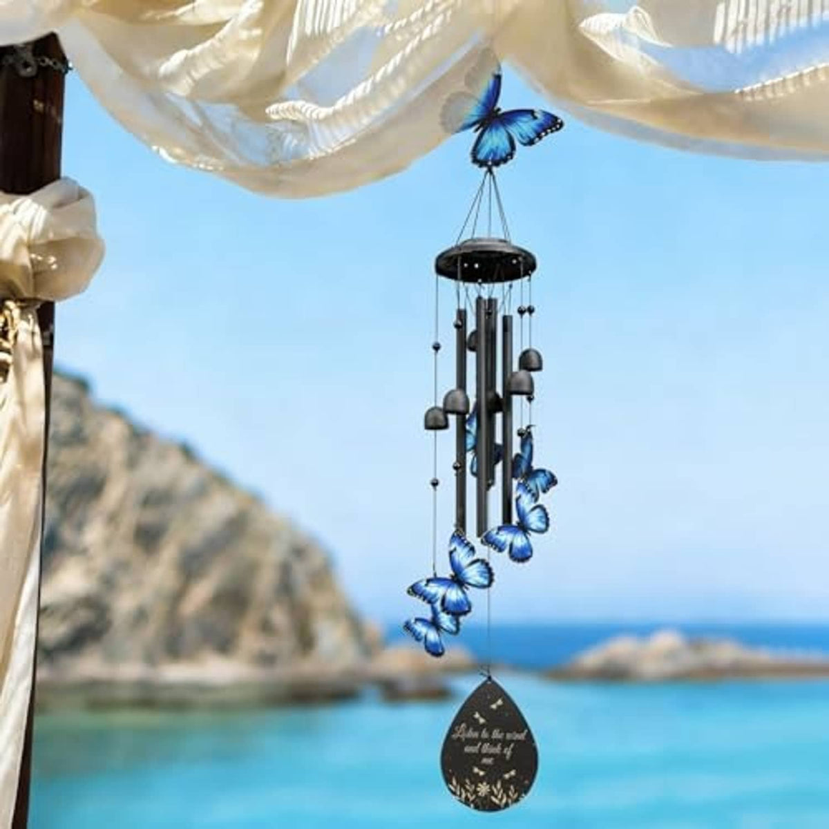 Metal wind chime with blue butterflies, vertical black tubes, and engraved keepsake tag