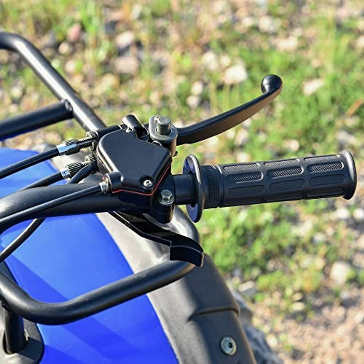ATV thumb throttle and brake lever on black handlebar grips with mounted control module