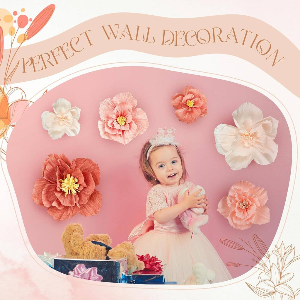 Cream and coral tissue paper flowers arranged around a circular backdrop for weddings