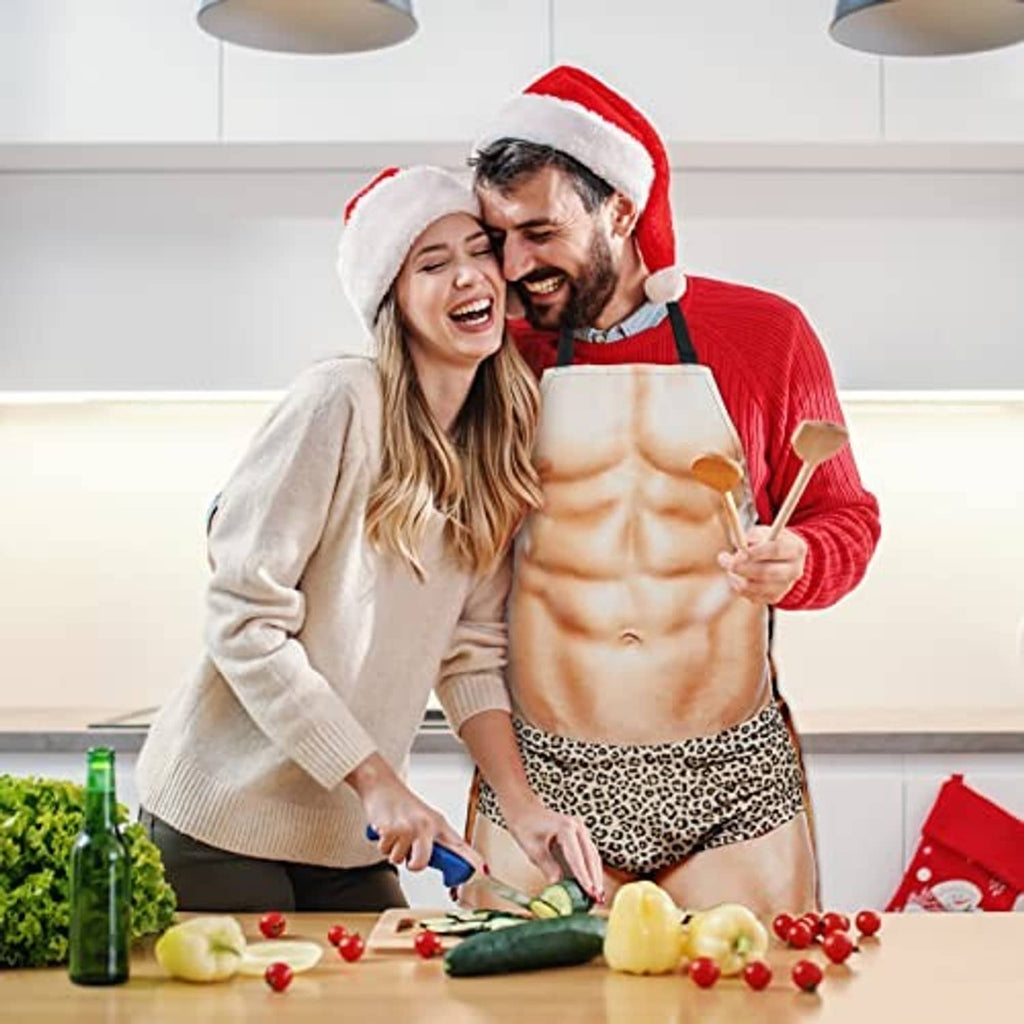 Muscular-print cooking apron with leopard waist panel and black straps, worn during prep