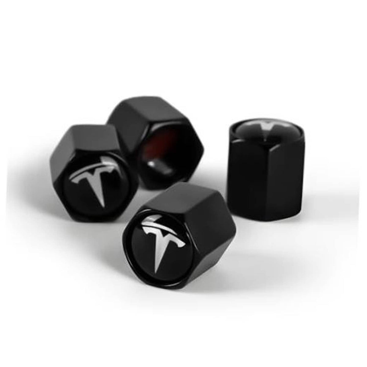 Black hex tire valve stem caps with Tesla logo, four-piece set