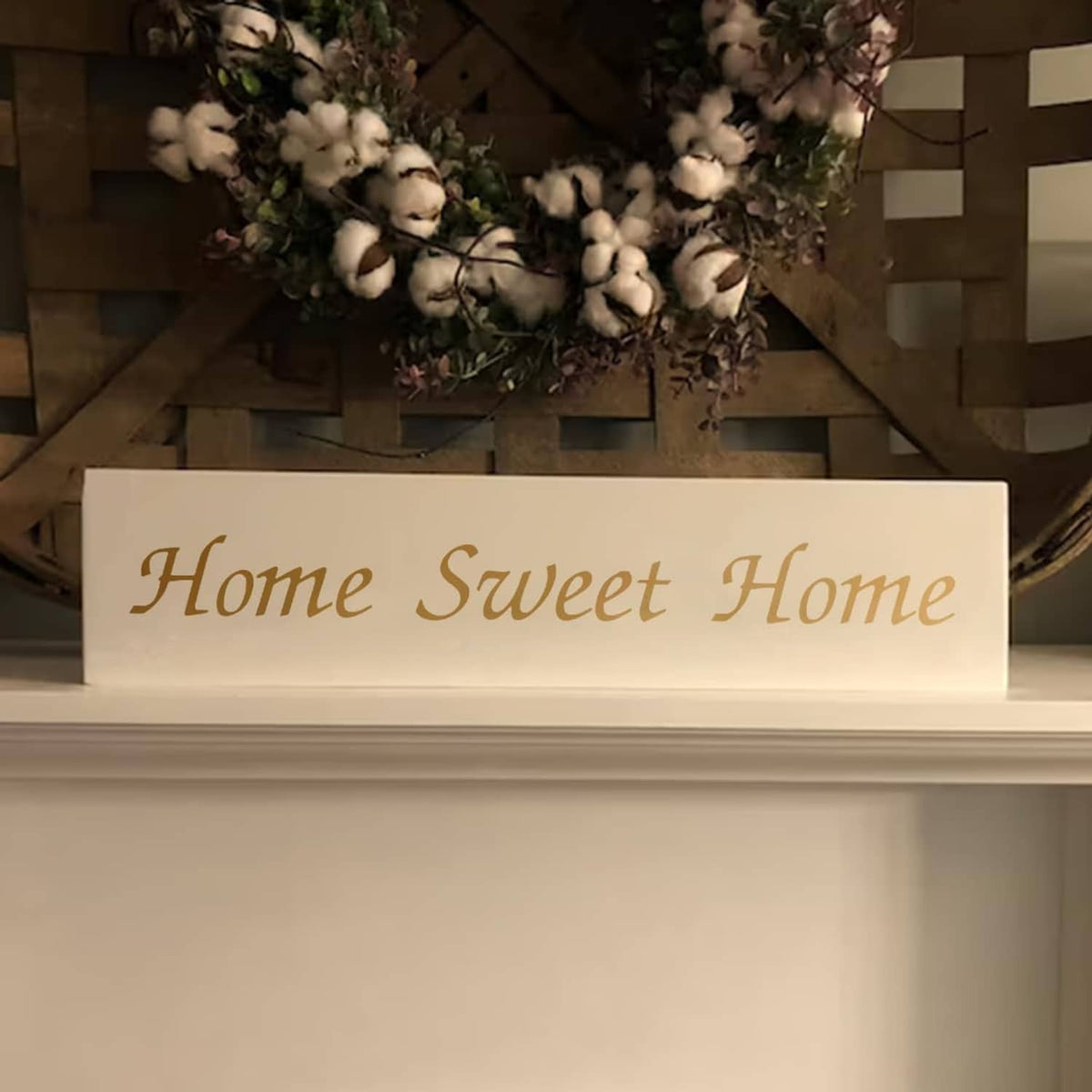 Rectangular wall sign made with letter stencils reading "Home Sweet Home"
