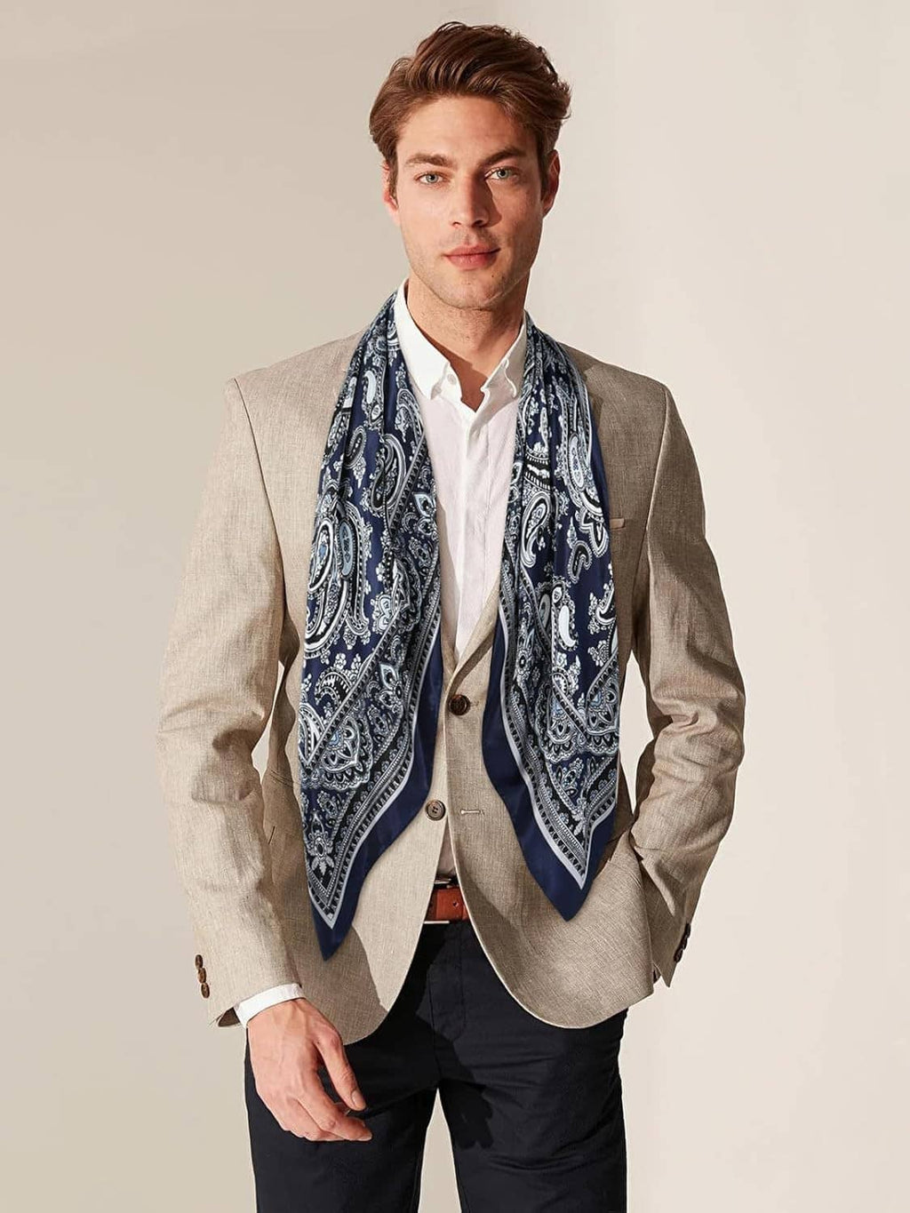 Navy and white paisley wild rag scarf worn at the neck with a tailored look