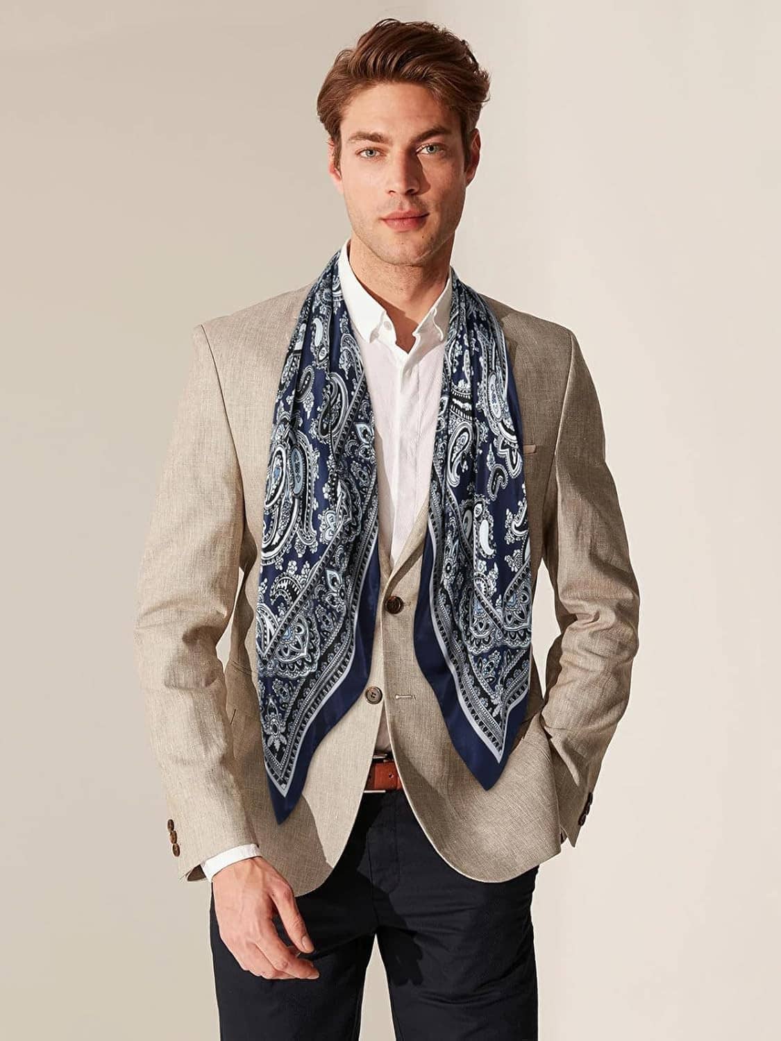Navy and white paisley wild rag scarf worn at the neck with a tailored look