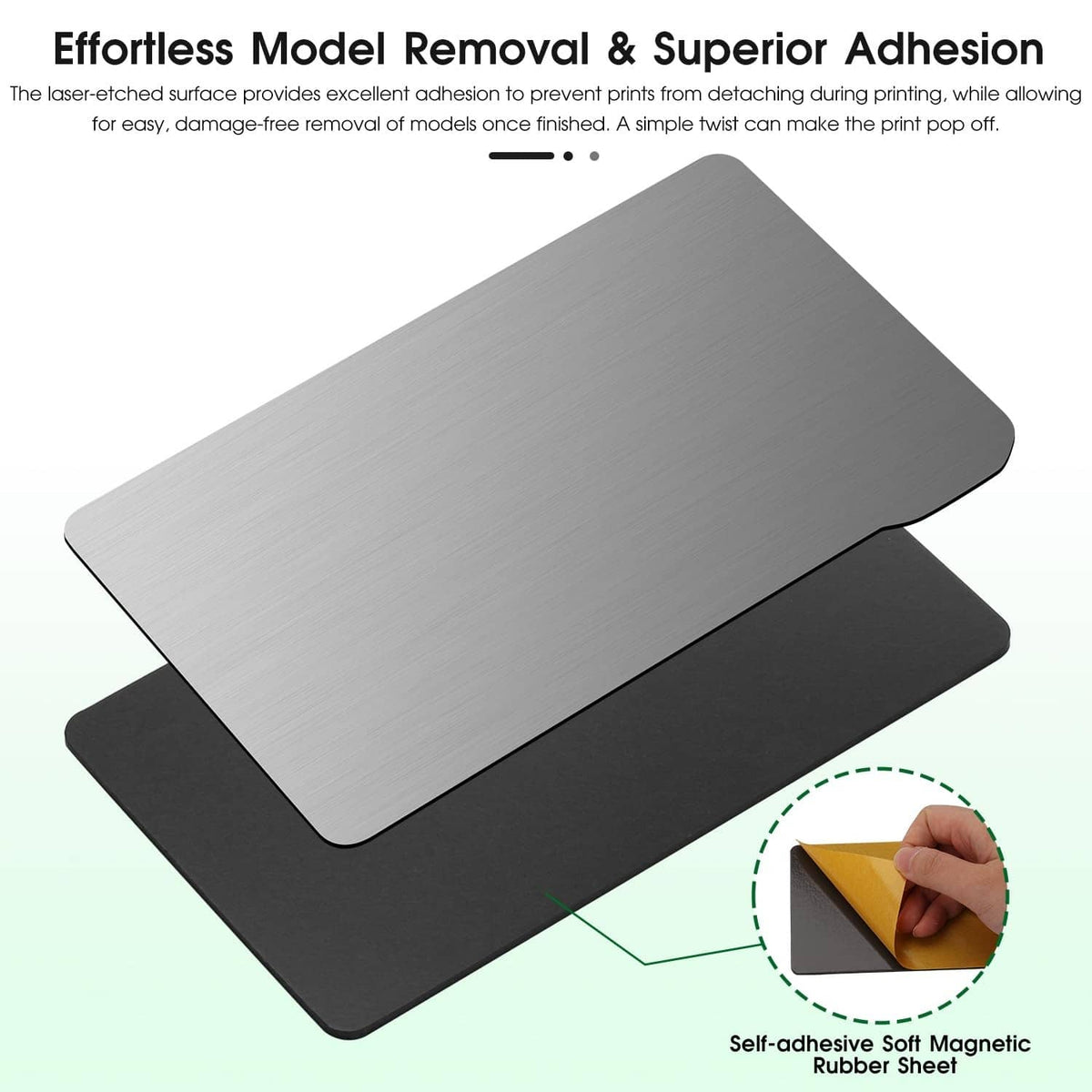 Silver resin build plate on black magnetic sheet with close-up of hand removing corner