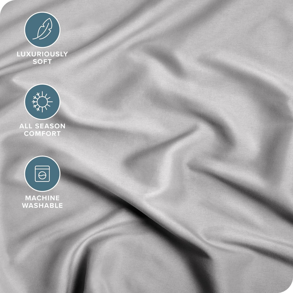 Light grey fitted sheet fabric close-up with soft wrinkle texture