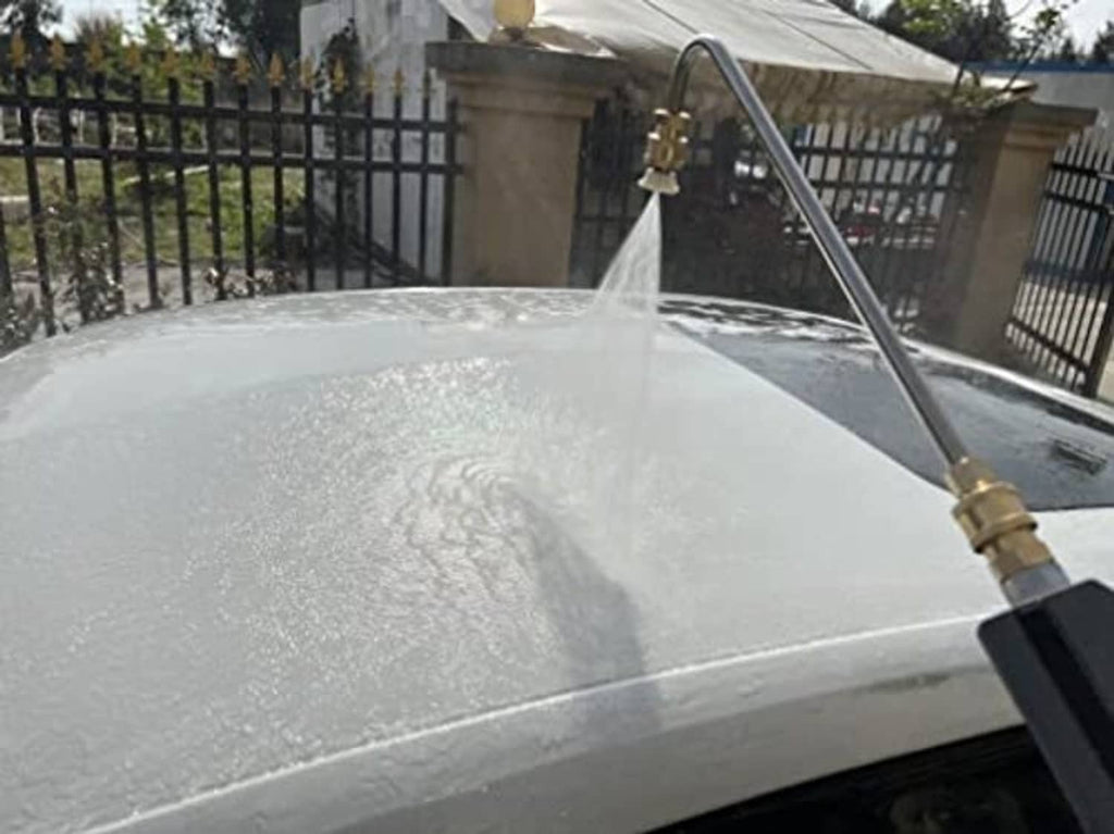 Angled pressure washer wand spraying water into a large round tank