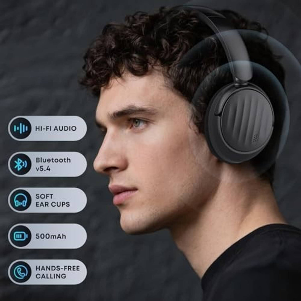 Black over-ear headphones worn by a person, showing ear cup detail and mic area