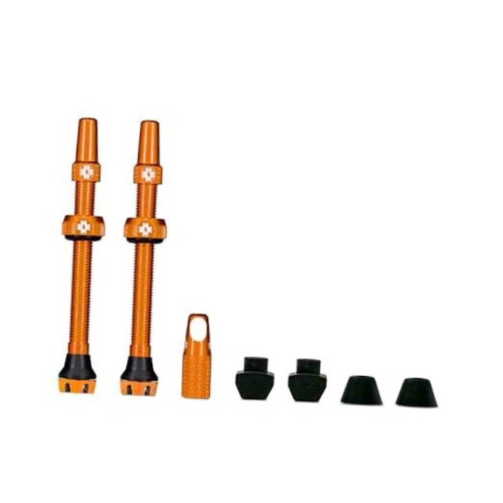 Orange Presta tubeless valve set with two stems, caps, and core removal tool.