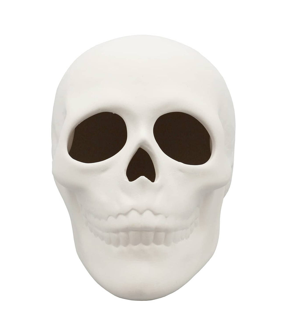 White ceramic bisque skull figurine with dark eye sockets and open nose