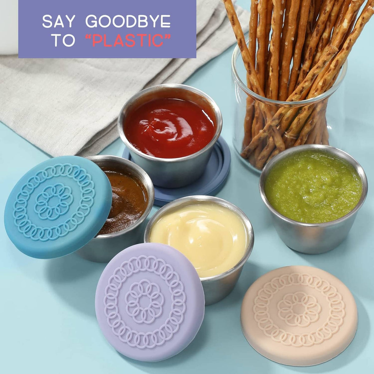 Reusable salad dressing containers with pastel silicone lids and stainless steel cups