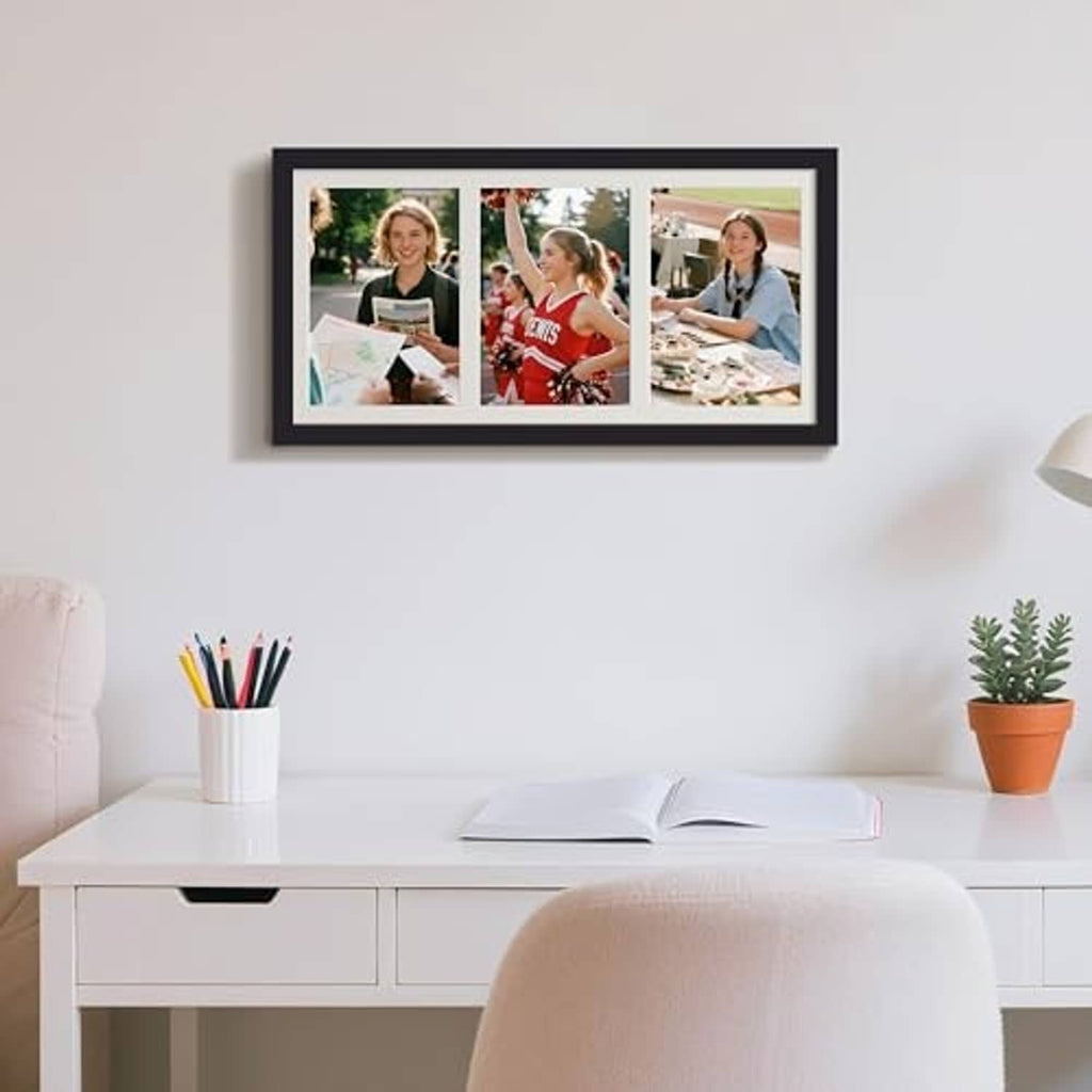 Black collage picture frame mounted on wall with three portrait photos
