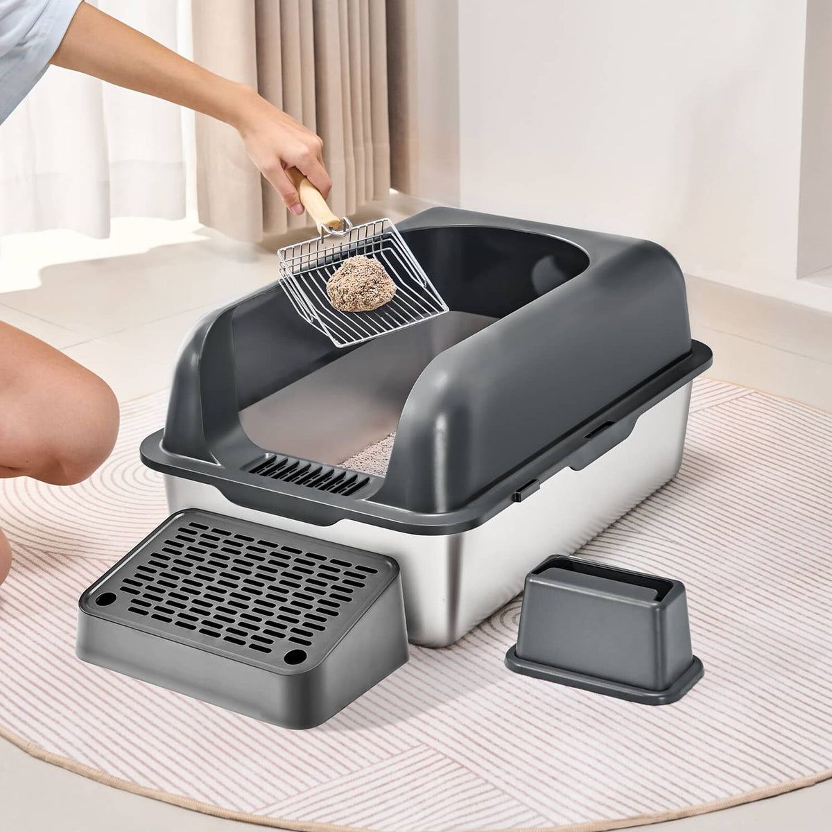 Covered cat litter box with lid open, litter scoop over tray, plus base pan
