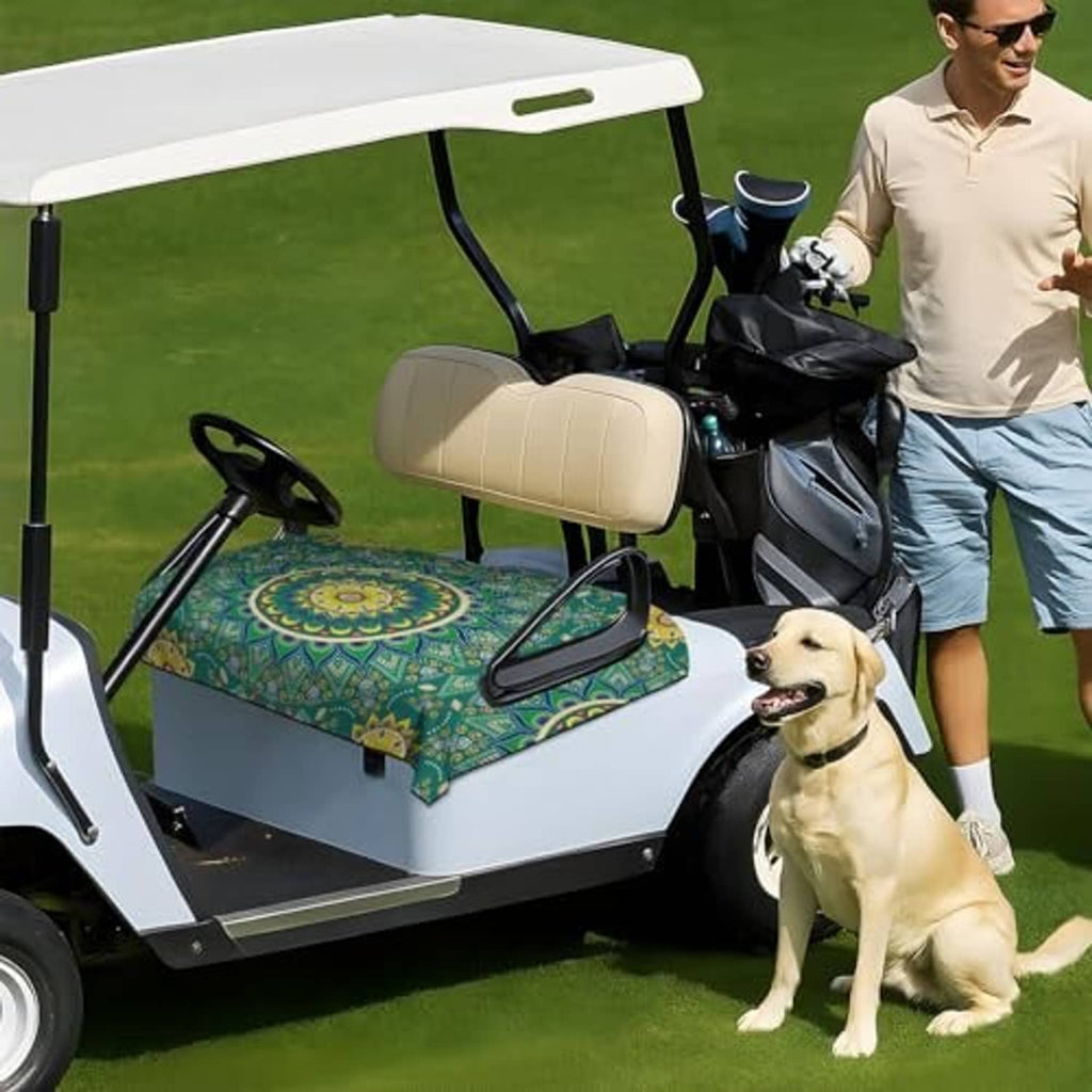 Green golf cart seat cover towel with mandala print on 2-seat bench, outdoors with dog