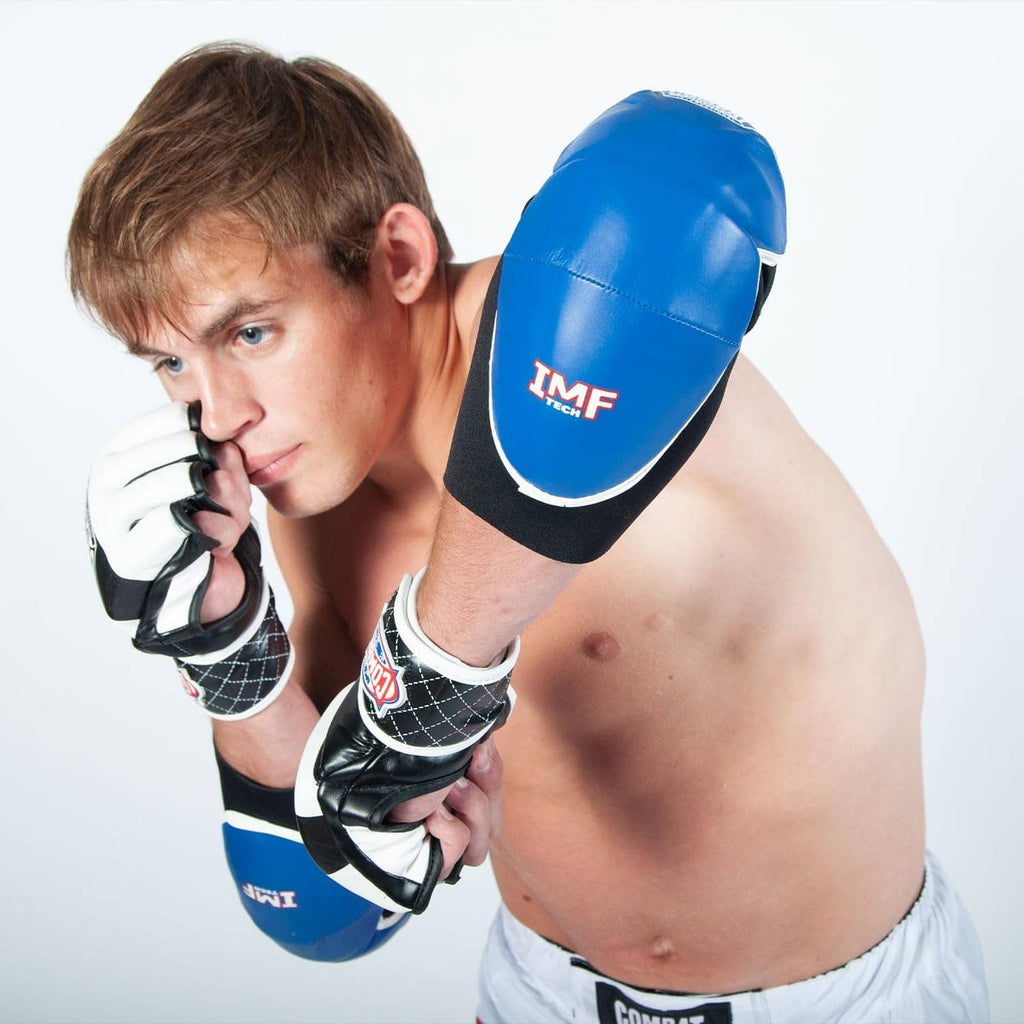 Blue MMA elbow pad on black neoprene sleeve with TMF logo and padded cap