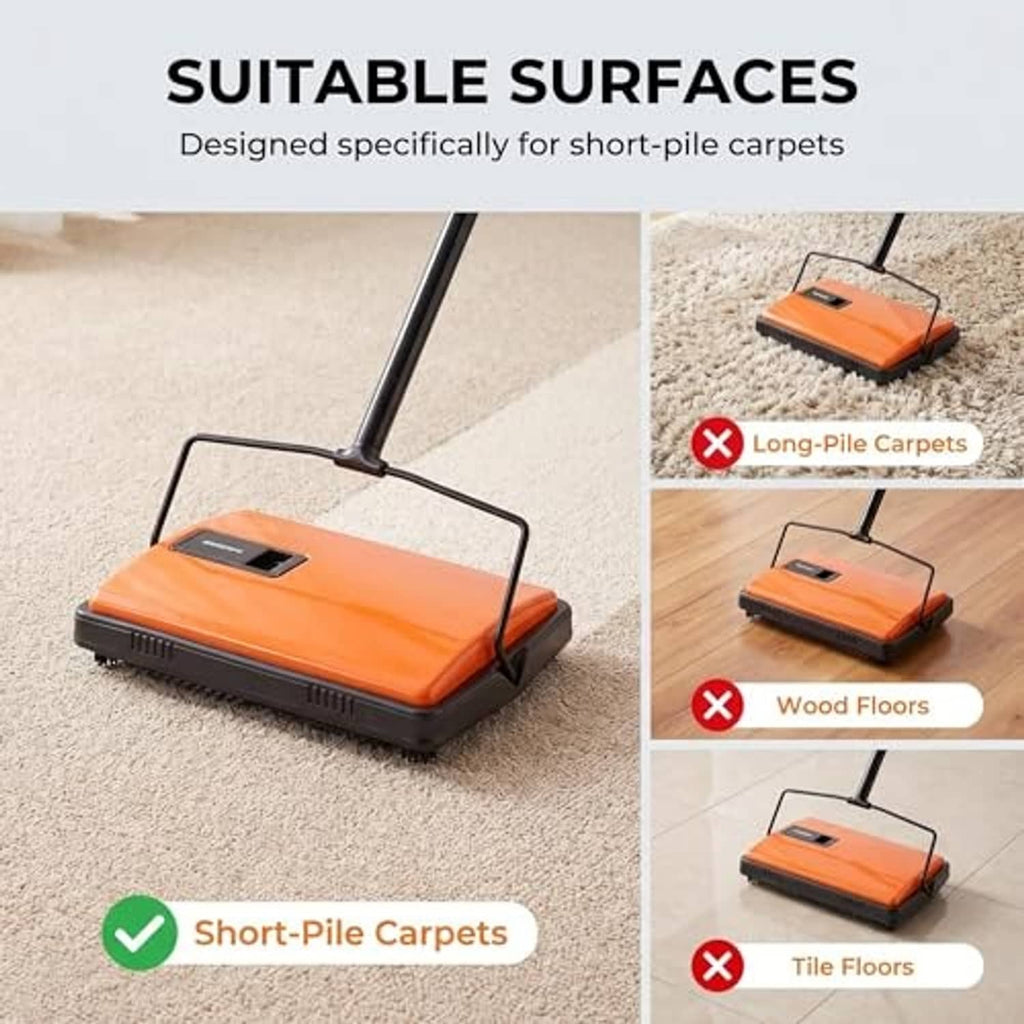 Orange carpet sweeper brush on short-pile rug, black base and handle