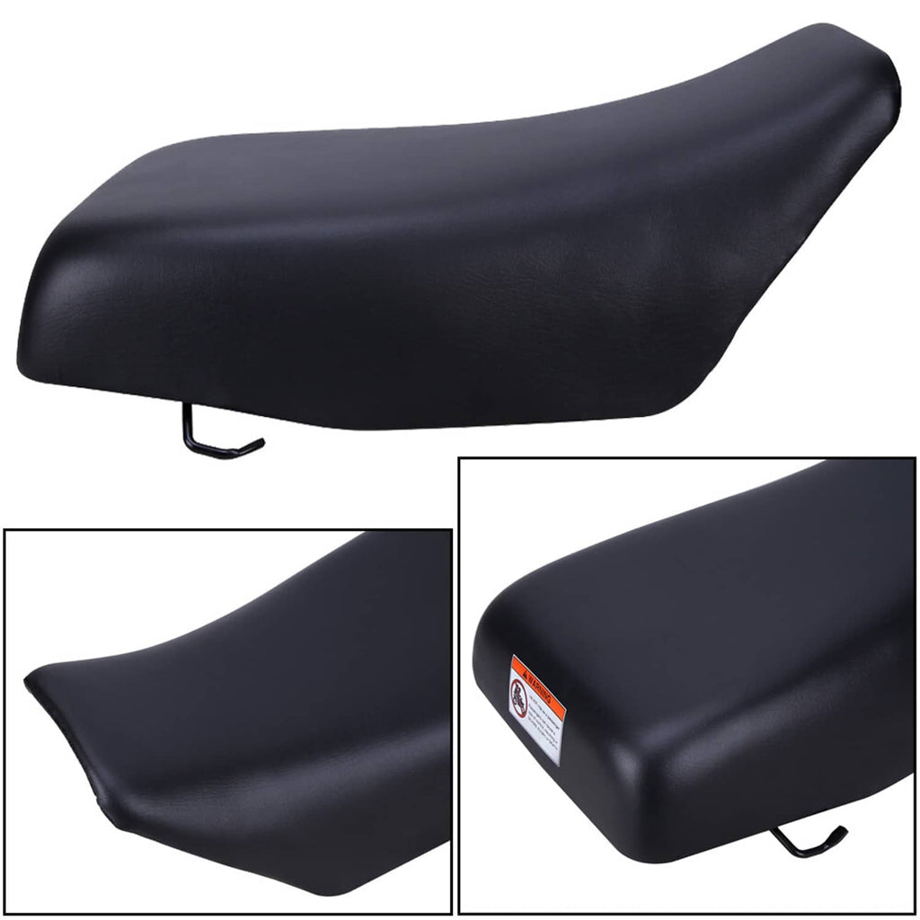 Black ATV seat close-up, contoured profile with rear mounting hook and safety label