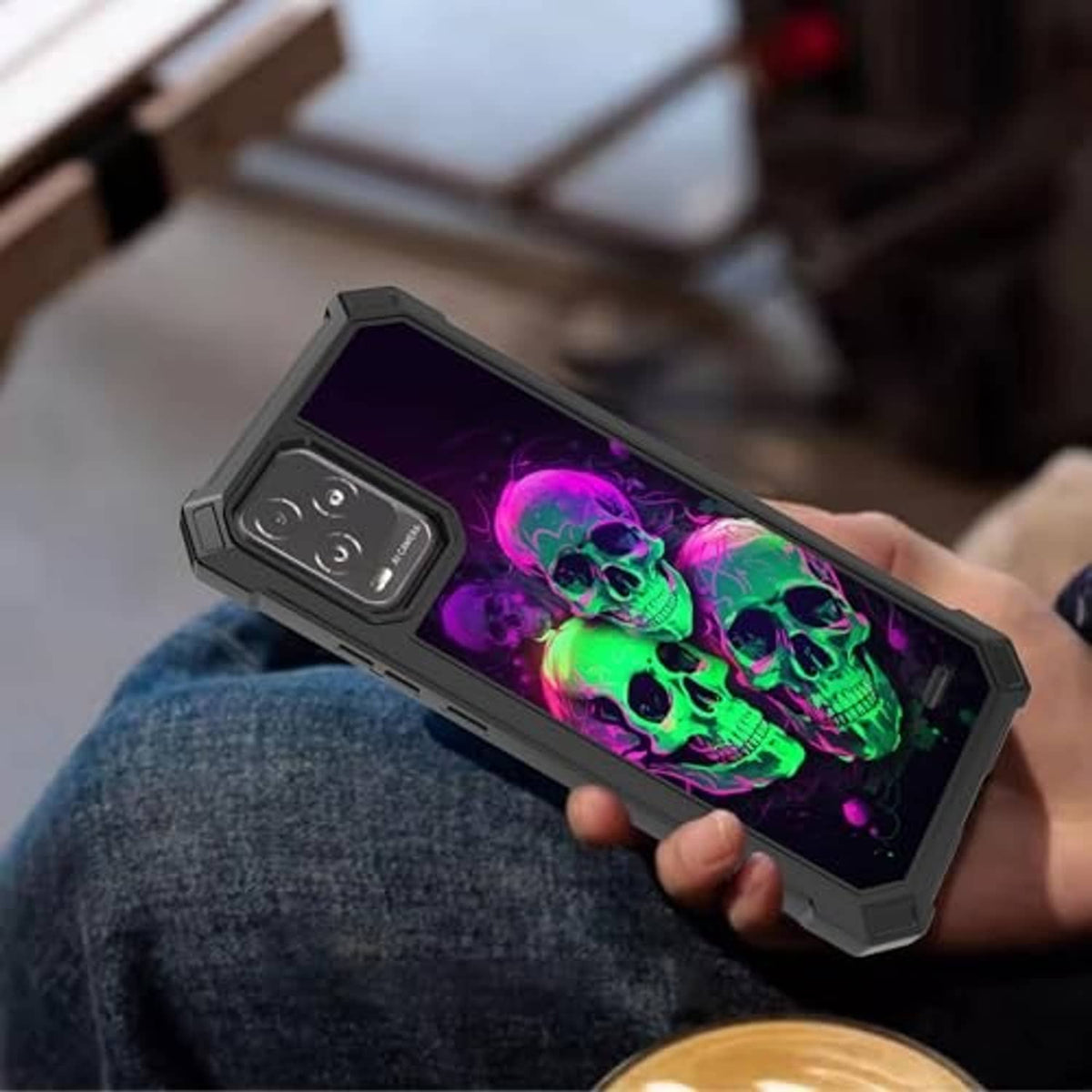 Rugged phone case with neon skull front graphic, dark bezel and thick edges