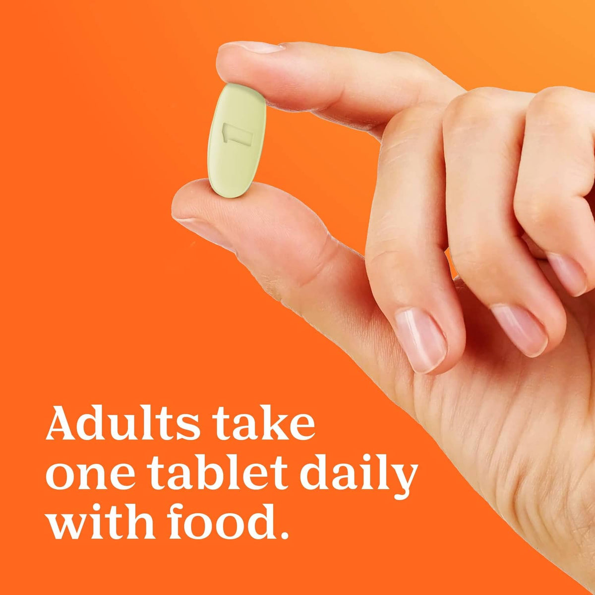 Hand holding a small white tablet, shown with women’s multivitamin usage message