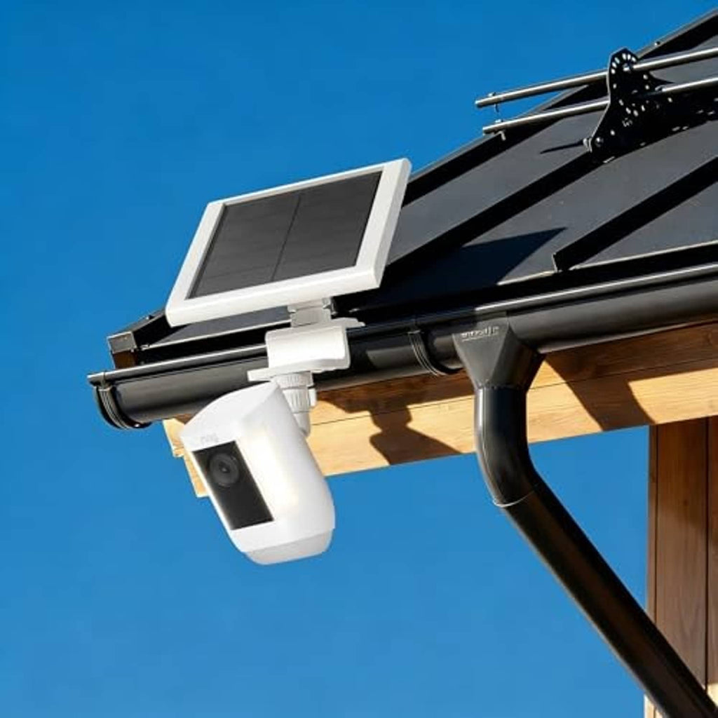 White gutter mount holding solar panel and camera under roof edge, angled