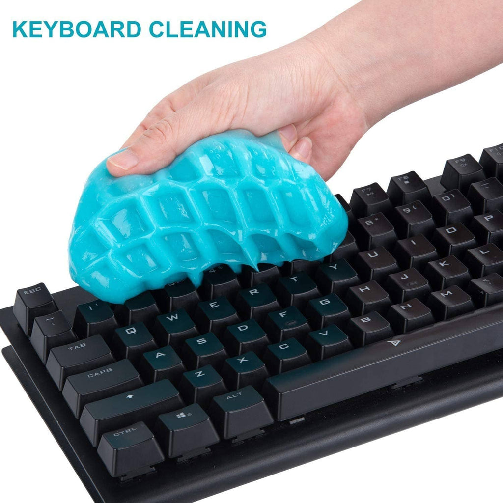 Blue cleaning gel putty pressed onto computer keyboard keys