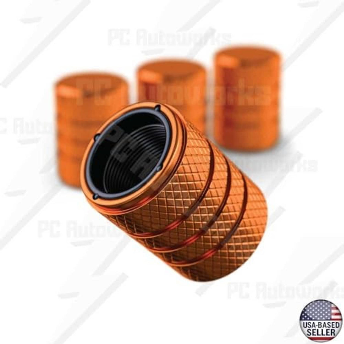 Amber orange valve stem caps, showing black inner seal and textured ridged body