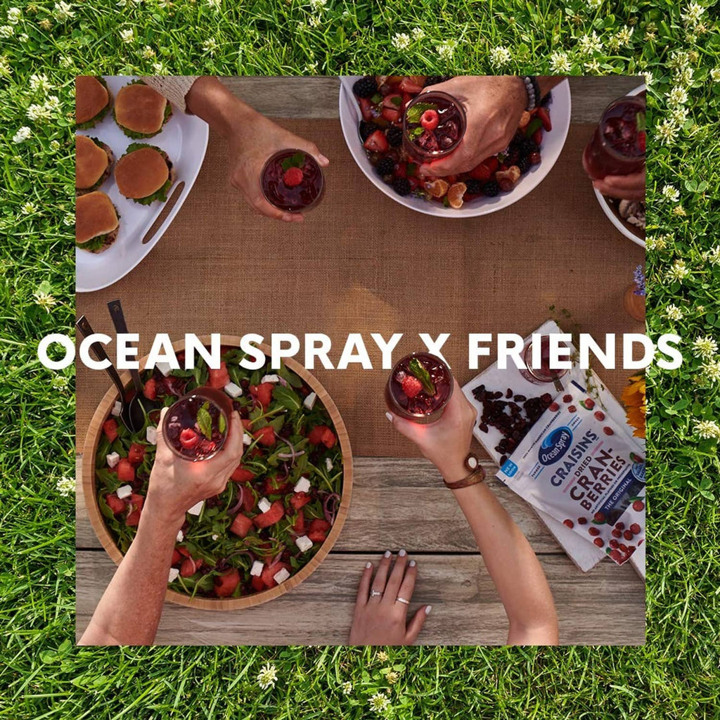 Ocean Spray Cran-Grape juice bottles on picnic table, hands reaching toward drinks