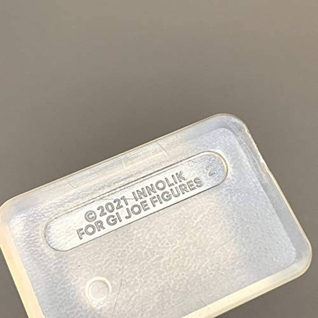 Clear plastic action figure stand with embossed branding on base