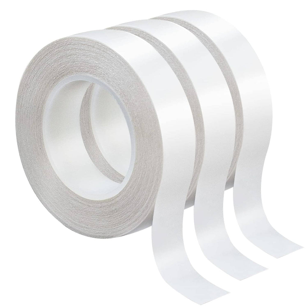 Double-sided tape rolls with white tape strip extending, gray center cores visible
