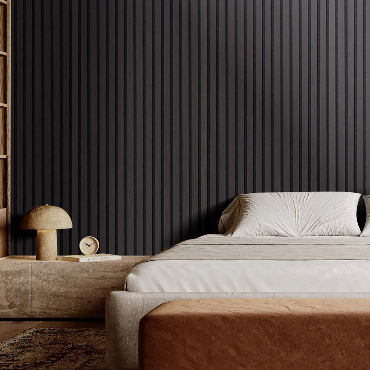 Black wood slat acoustic wall panel with vertical grooves behind a bed