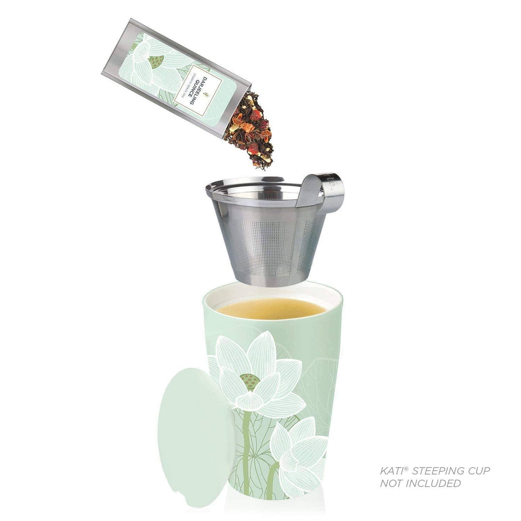Loose leaf tea steeping into a cup using a mesh infuser and a sampler packet