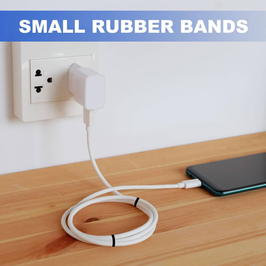 Small flat white silicone rubber band securing a coiled cable on a desk