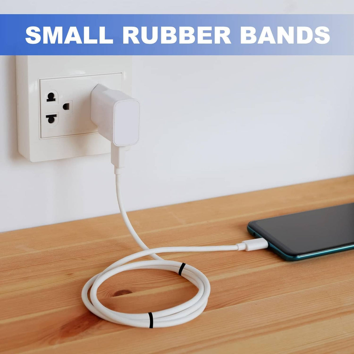 Small flat white silicone rubber band securing a coiled cable on a desk