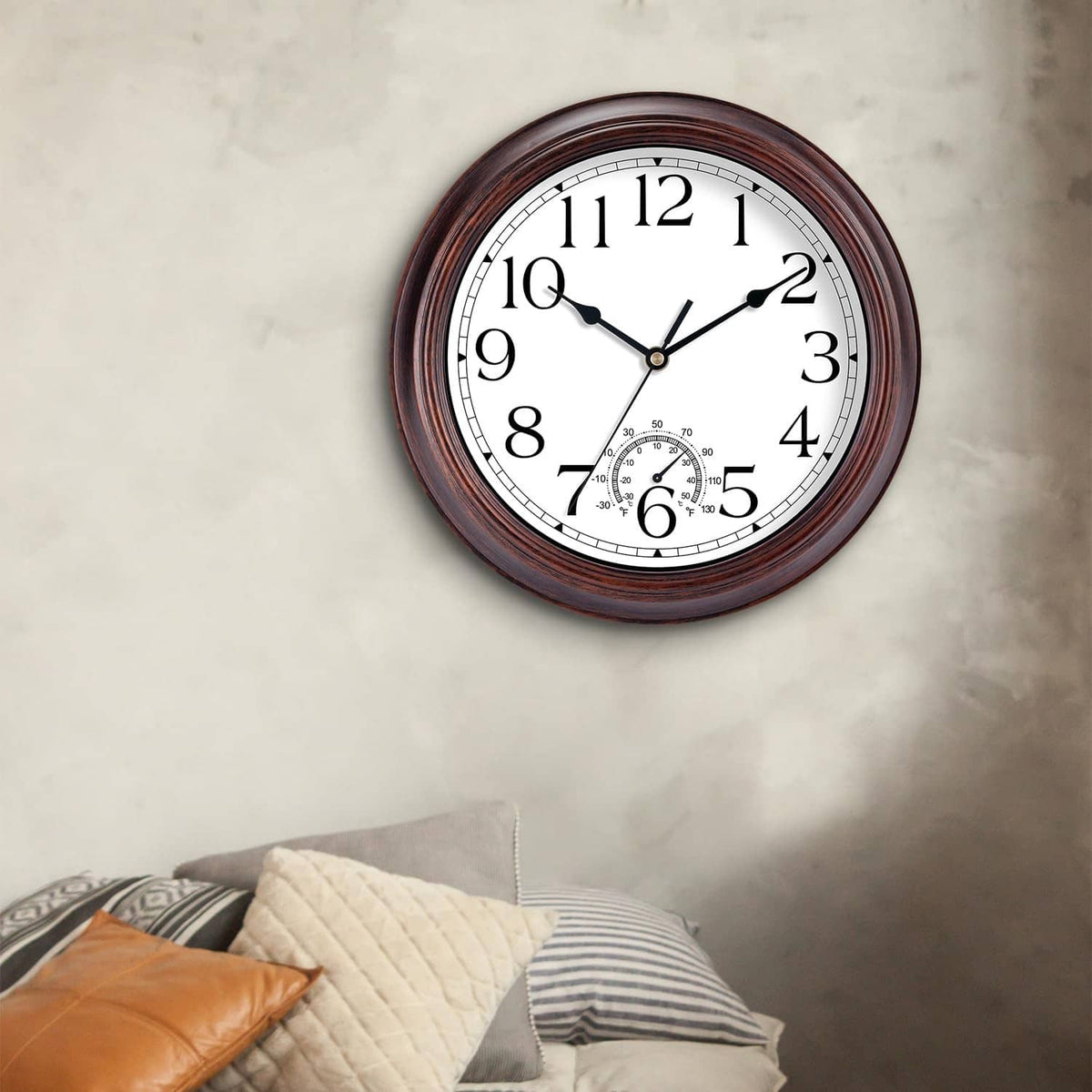 Round outdoor wall clock with copper-red rim and thermometer subdial beneath the 6.